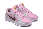 Angled view of the pink basketball shoes and their lace-up design.