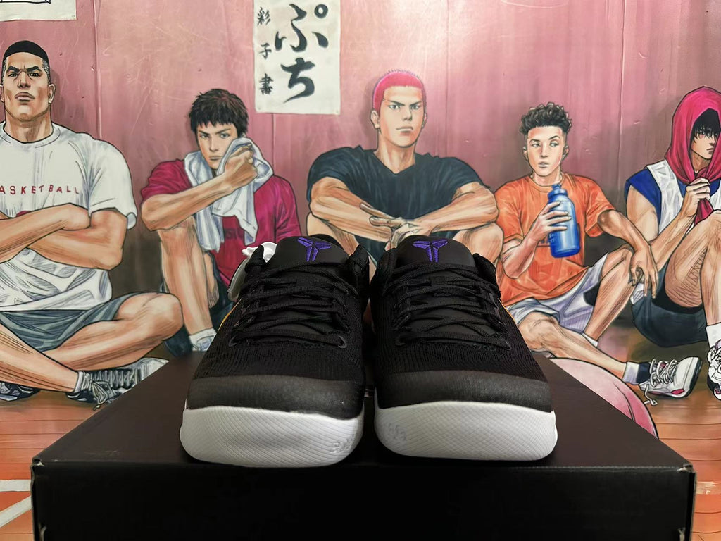Front view of black Nike basketball shoes with purple tongue details and white outsoles