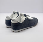 Rear three-quarter view showing the white heel accents and carbon gray heel panels.