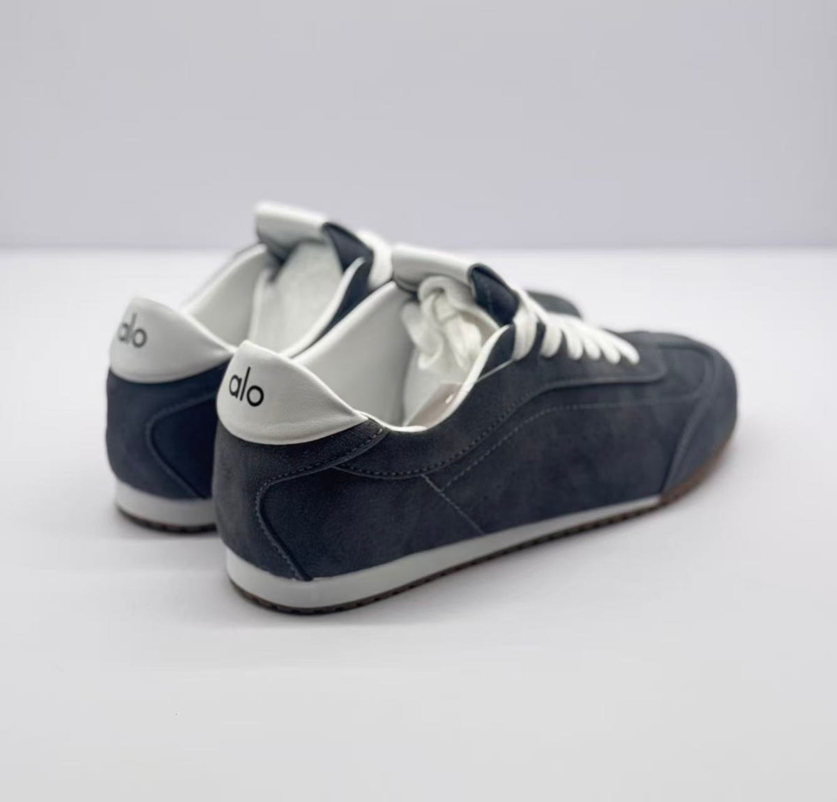 Rear three-quarter view showing the white heel accents and carbon gray heel panels.
