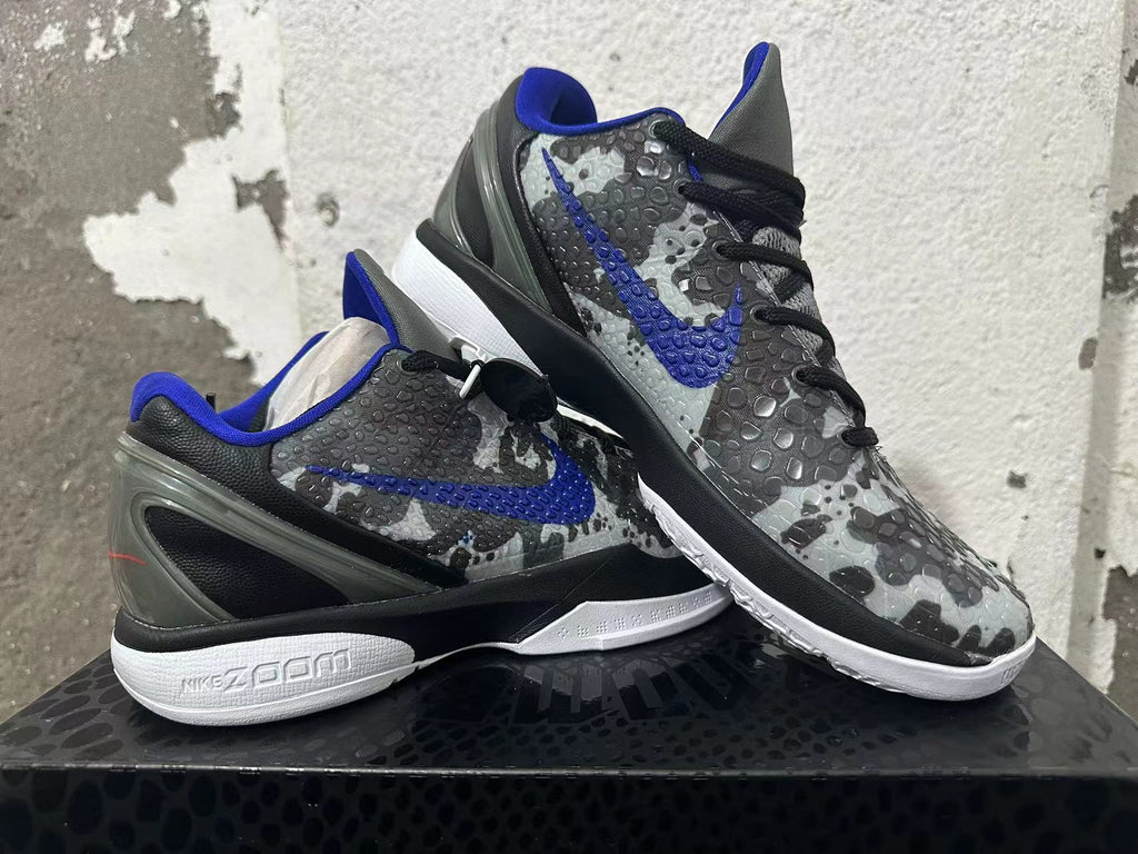 Pair of gray camouflage basketball shoes with blue accents shown at an angle