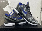 Pair of gray camouflage basketball shoes with blue accents shown at an angle
