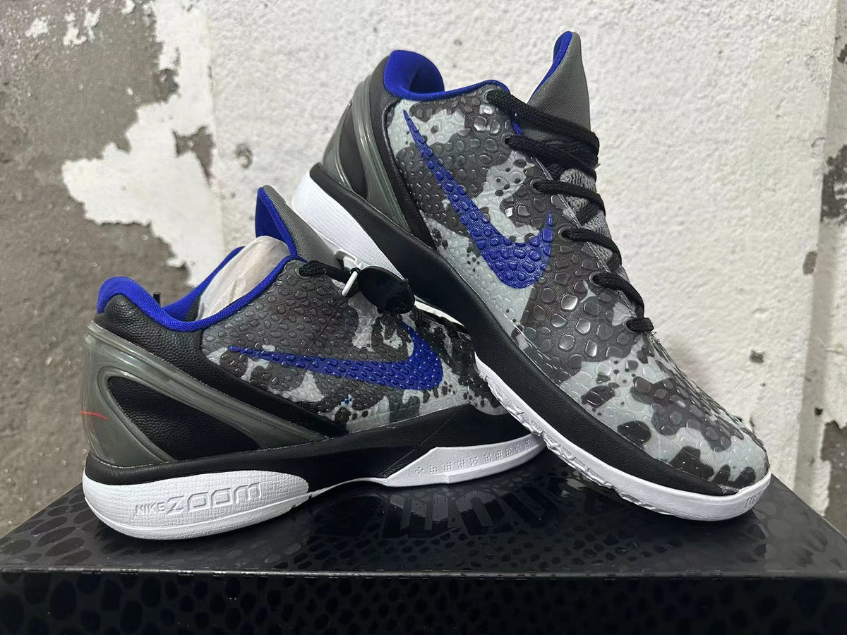 Pair of gray camouflage basketball shoes with blue accents shown at an angle