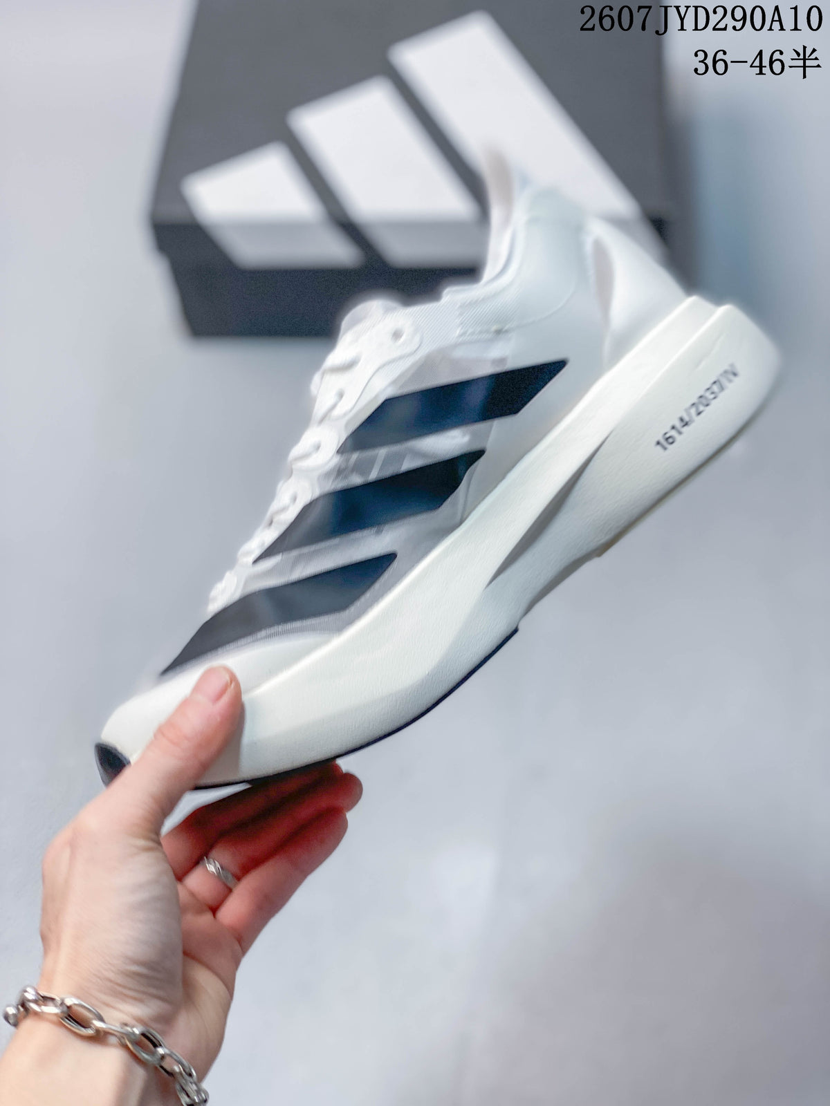 Side view of the sneaker showing layered dark navy stripes and the sculpted sole.