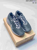 Pair of dark gray Nike trail sneakers displayed on a Nike shoe box, with white detailing and patterned laces.