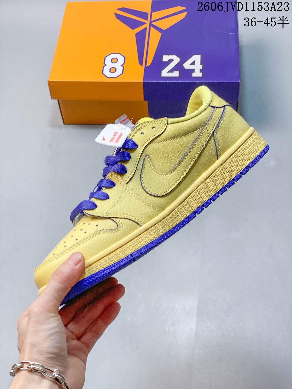 Side view of the yellow low-top sneaker with purple laces and outsole