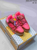 Pair of pink and brown Louis Vuitton Trainer low-top sneakers on a patterned box