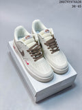 Pair of white Nike Air Force 1 '07 LV8 low-top sneakers with brown laces and accents on a shoebox.
