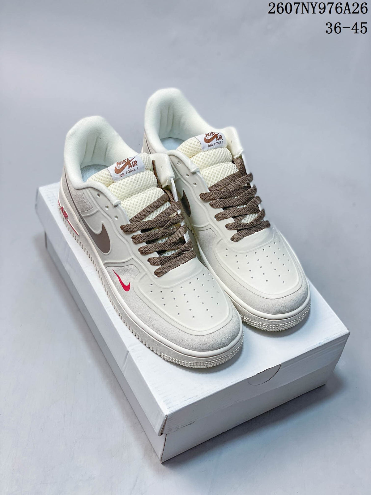 Pair of white Nike Air Force 1 '07 LV8 low-top sneakers with brown laces and accents on a shoebox.