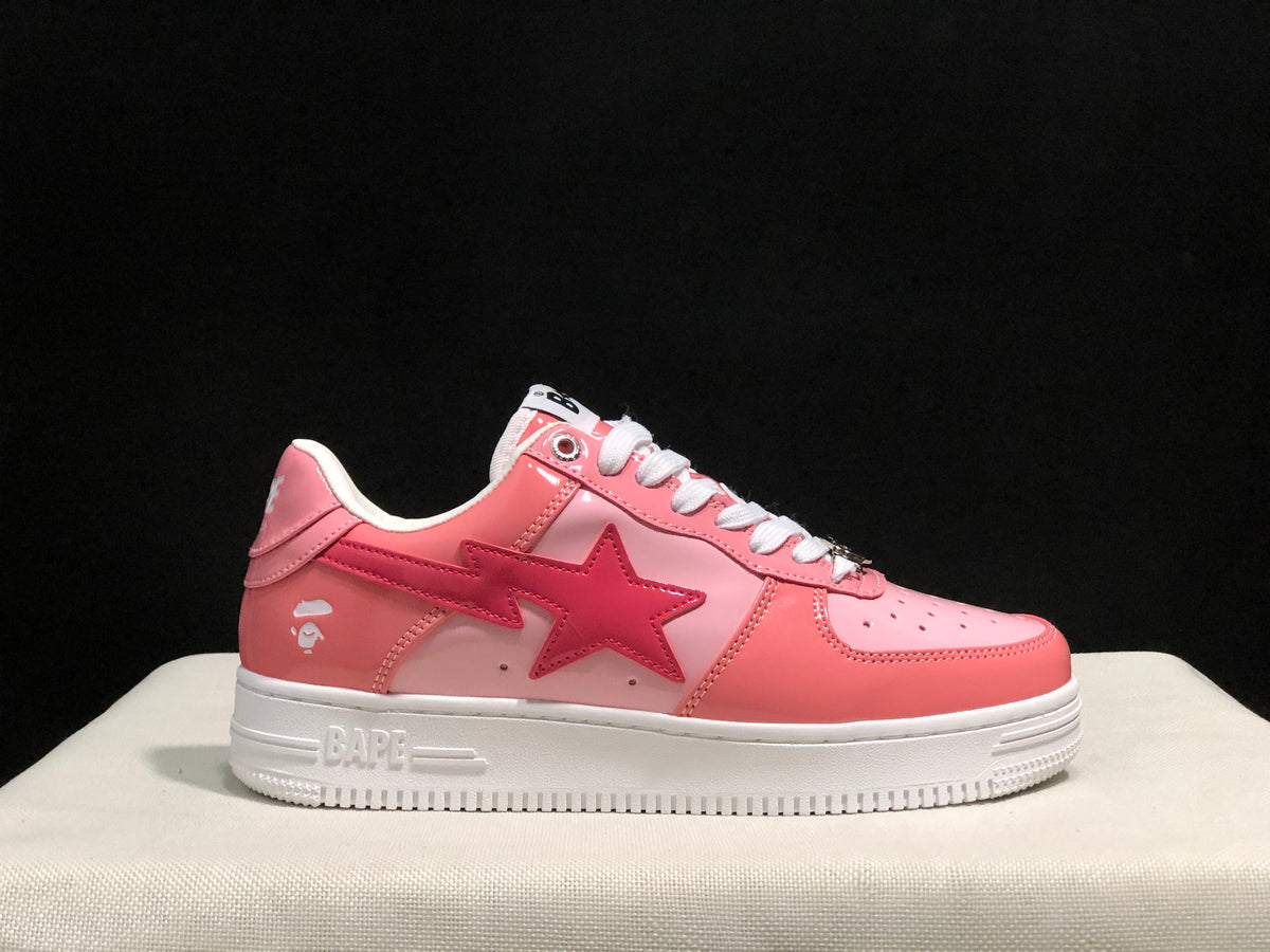 Opposite side profile showing the pink upper, BAPE side branding, star graphic, and white rubber outsole.