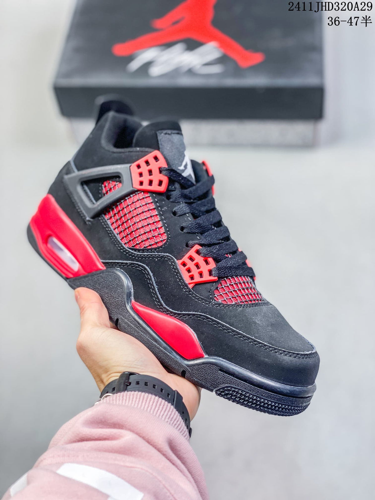Close-up of a black high-top sneaker with red eyelets, red side mesh, and red midsole accents.