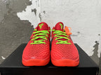 Front view of red Nike Kobe basketball shoes with bright green laces and tongue emblems