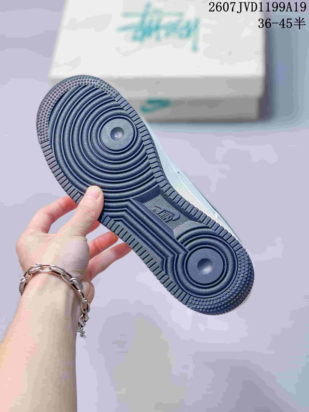 Close-up of the dark rubber outsole showing concentric circular traction patterns and textured edges.