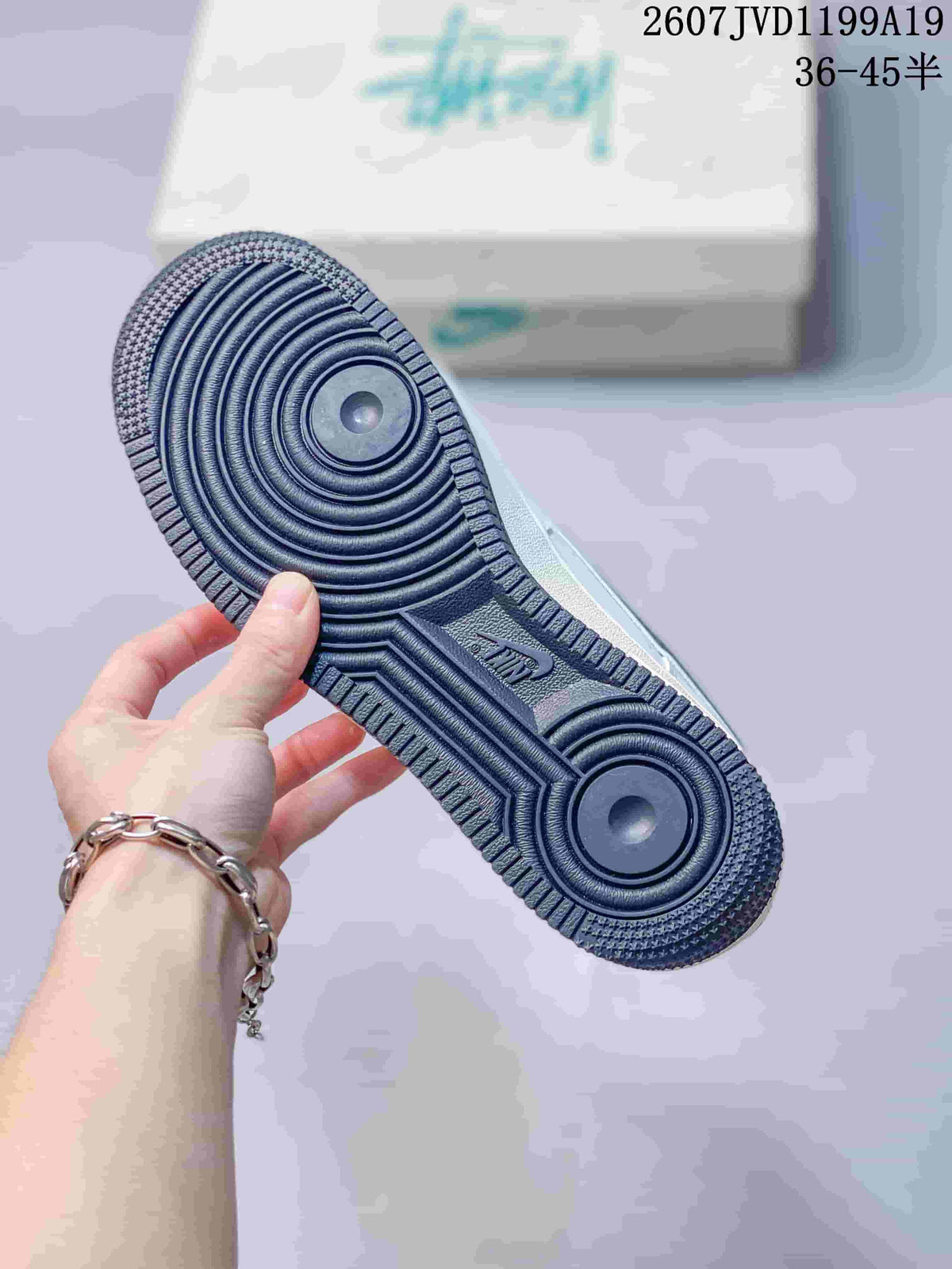 Close-up of the dark rubber outsole showing concentric circular traction patterns and textured edges.
