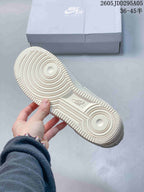 Close view of the cream textured rubber outsole with circular traction details and Nike branding.