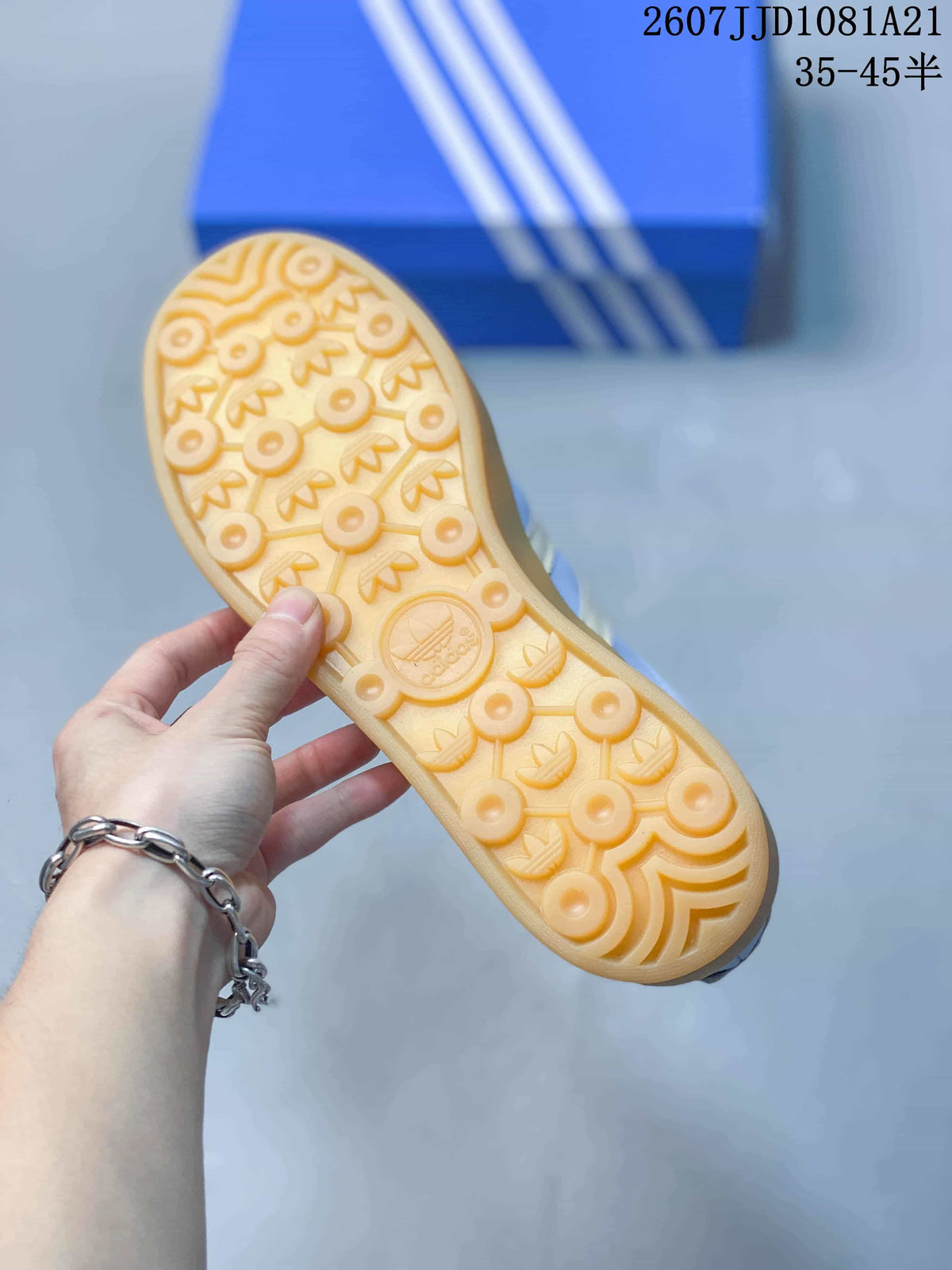 Close view of the gum-colored outsole with a repeating adidas trefoil tread pattern.