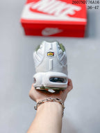 Rear view of the white sneaker showing the heel structure, visible air unit, and green outsole detail.
