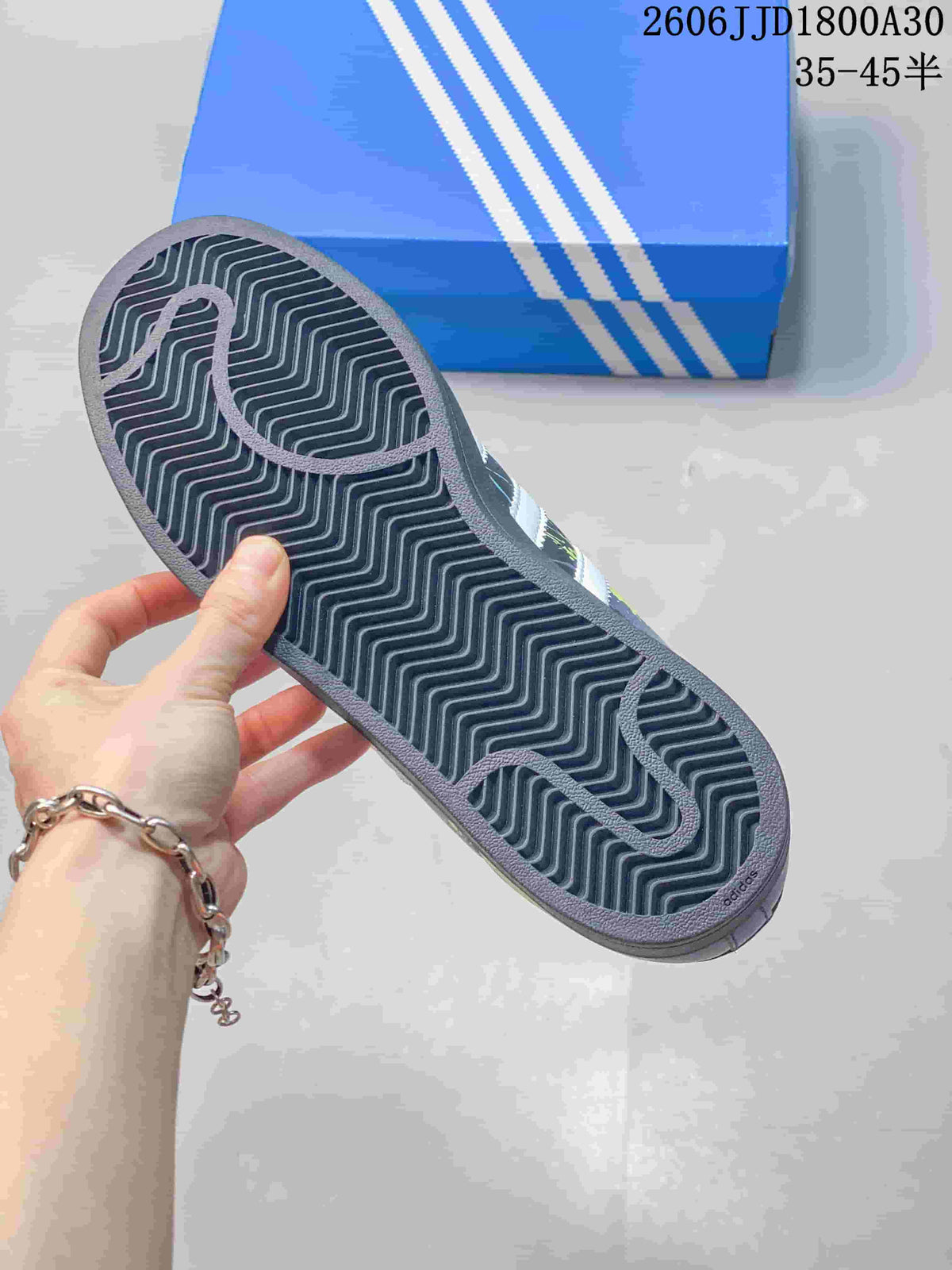 Close-up of the sneaker outsole showing a dark zigzag tread pattern.