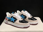 Three-quarter front view highlighting the cream toe and eyestay panels, glossy black sections, blue star emblems, and white laces.