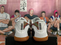 Rear view of white basketball shoes with patterned panels and gum-colored outsoles