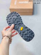 Close-up of the black lugged outsole showing multidirectional tread and visible Vibram branding.