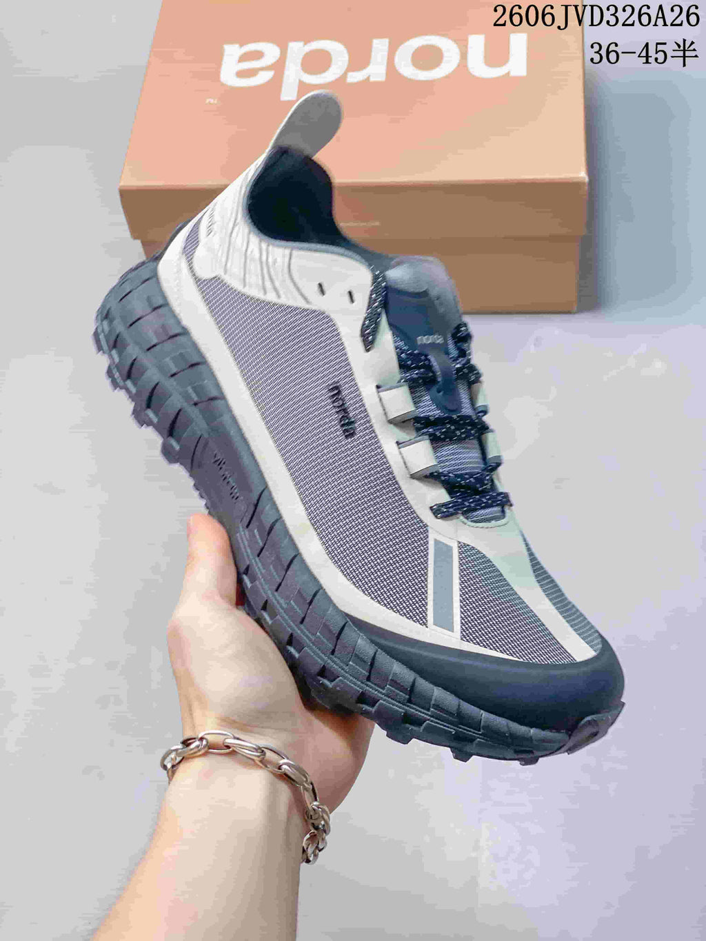 Angled side view highlighting the shoe upper and thick, patterned outsole.