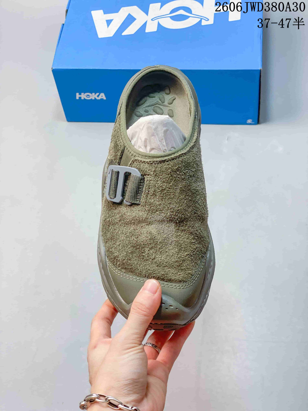 Top view of the mule sneaker showing its textured upper and buckle detail