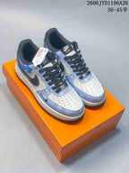 Blue-and-white patterned low-top sneakers with dark laces on an orange box