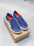 Pair of navy Adidas TERREX slip-on shoes on a TERREX box, with the product code and size range visible above.