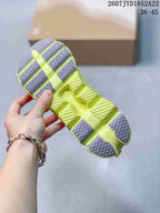 Underside view of the lime yellow sneaker showing the segmented outsole, gray traction sections, and CloudTec marking.