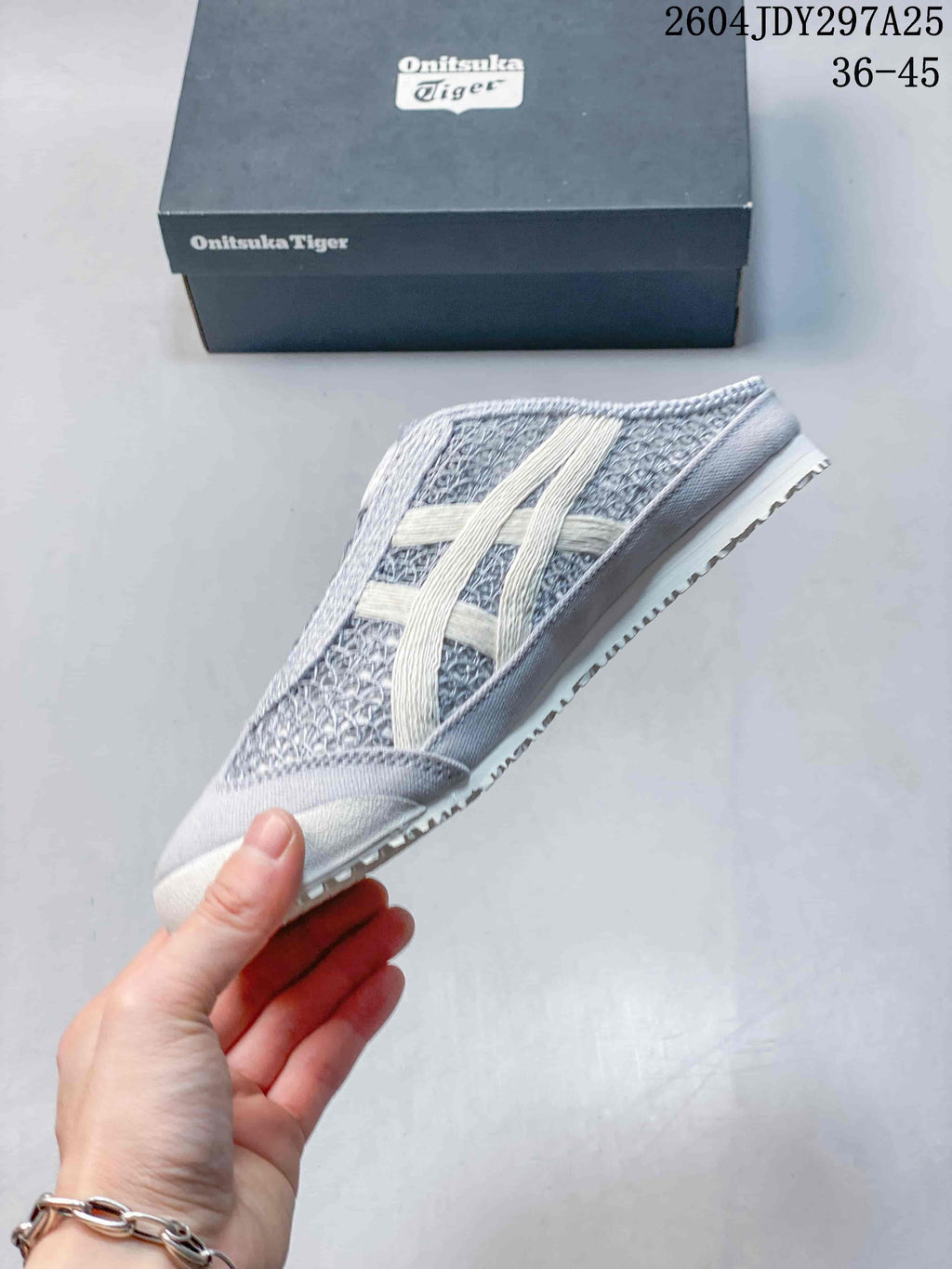Side profile highlighting the textured upper, contrasting stripes, and low-profile sole.