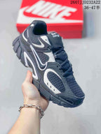 Three-quarter side view of a black and white Nike V5 RNR sneaker showing the mesh upper, contrast overlays, laces, and sculpted outsole.
