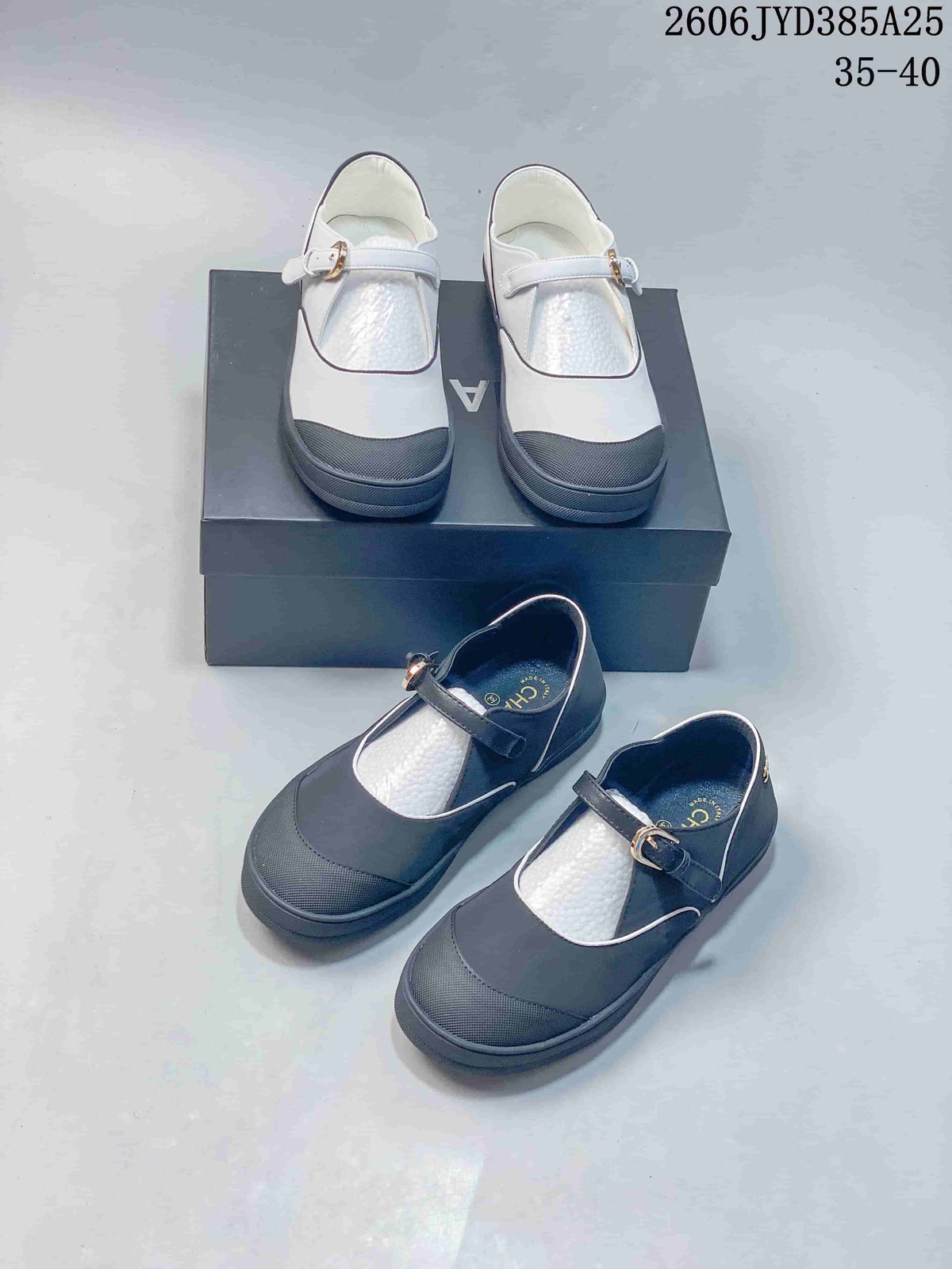 White and charcoal Mary Jane flats shown together from above and at an angle.