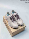 Pair of white ECCO Biom C low-top sneakers displayed on a shoebox, showing the lace-up front, perforated side panels and textured outsole.