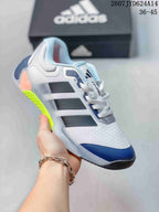 White adidas Dropset 4 training shoe with black and navy details and a bright yellow-green outsole accent.