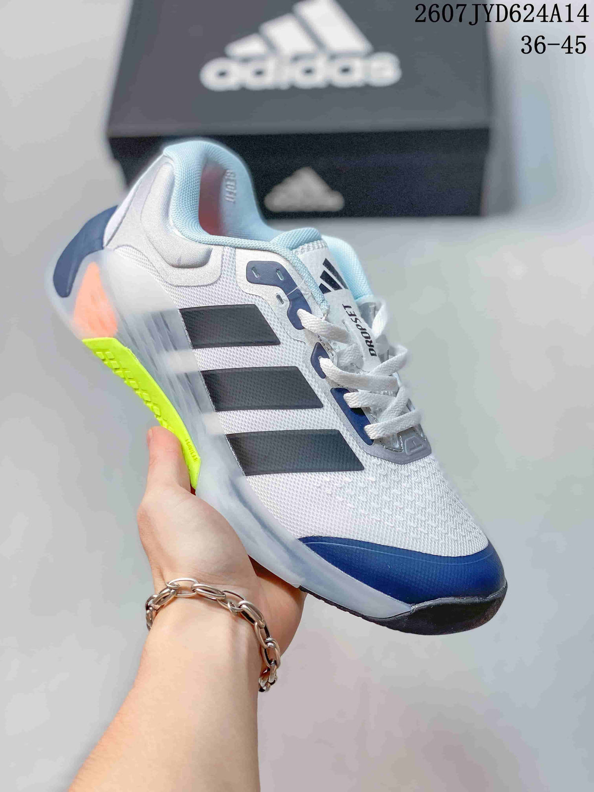 White adidas Dropset 4 training shoe with black and navy details and a bright yellow-green outsole accent.