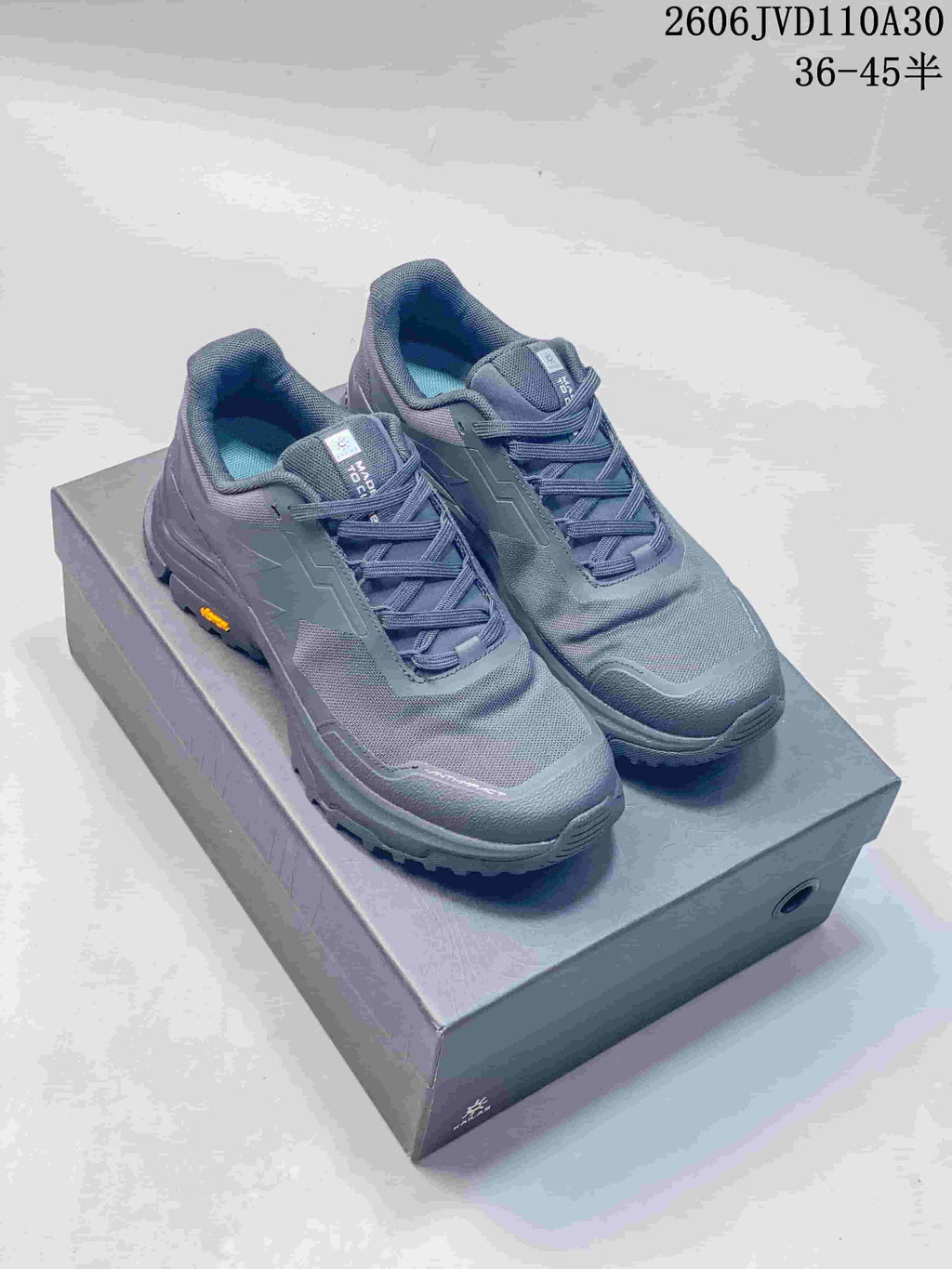 Gray KAILAS low-top hiking shoes shown from above on a box