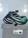 Grey, black and green New Balance sneaker displayed on its box, with the box label visible.
