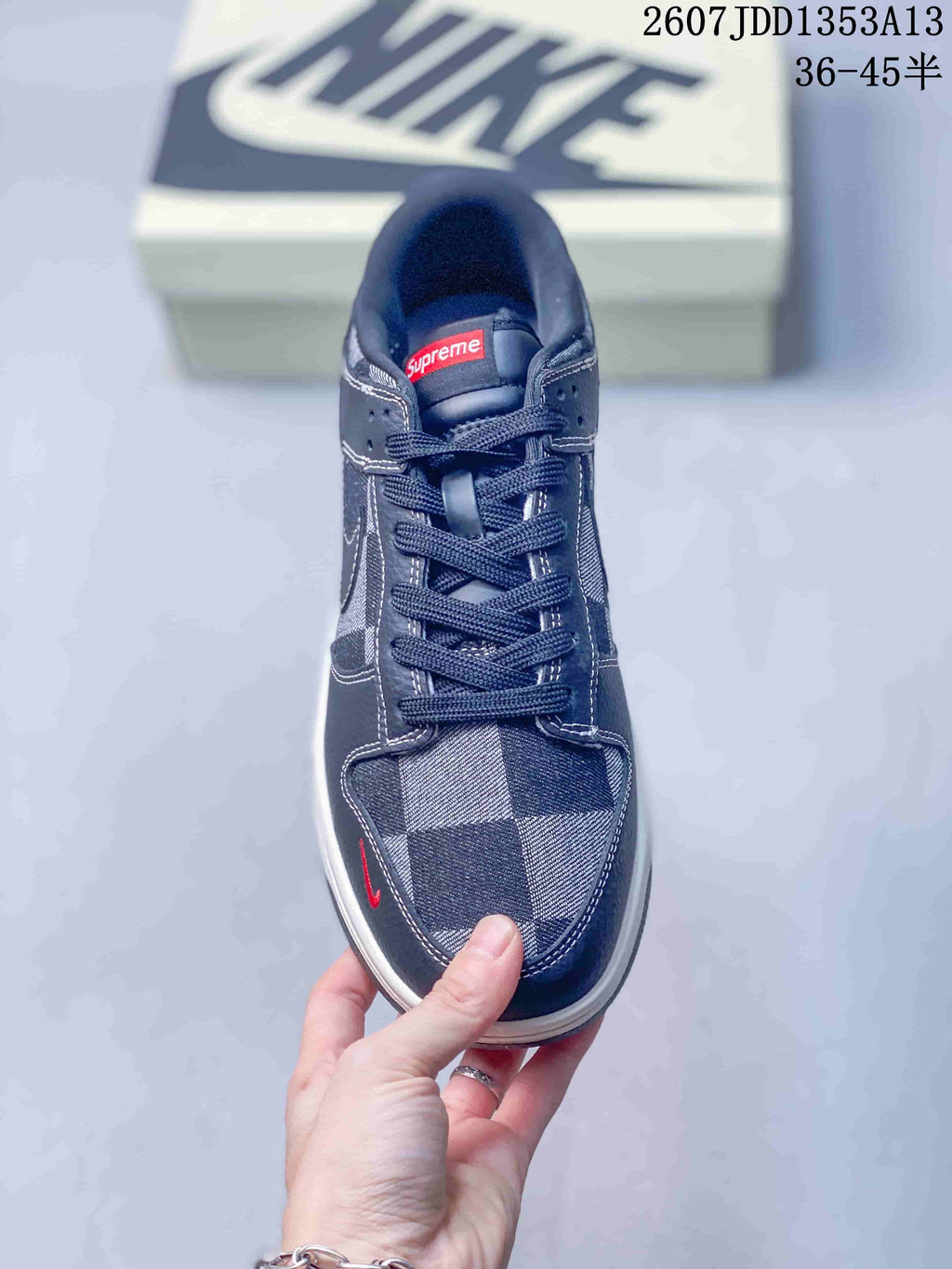Top view showing the dark laces, plaid toe box, red tongue label, and low-top shape.