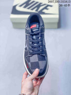 Top view showing the dark laces, plaid toe box, red tongue label, and low-top shape.