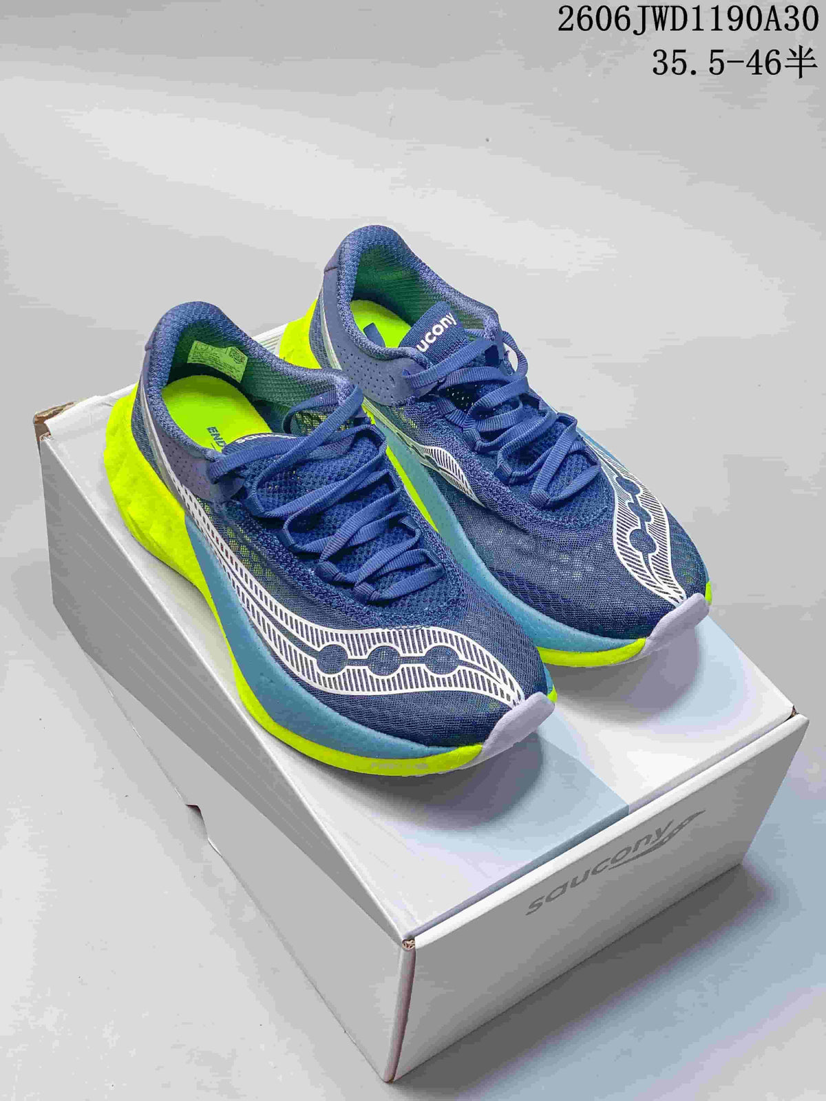 Navy Saucony running shoes with white and neon yellow accents