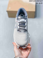 Top view of the sneaker showing the rounded toe, layered tongue, and dark gray laces.