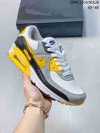 Gray, white, black and yellow Nike Air Max 90 sneaker