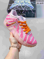 White and pink Nike Ja 3 basketball shoe with orange laces