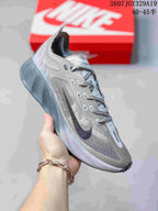 Angled side view of the gray Nike Ava X Rover sneaker showing the patterned upper, lace-up construction, and textured outsole edge.
