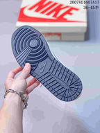 Close view of the dark textured outsole with circular pivot detailing and patterned tread.