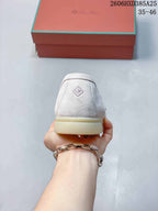 Rear view of the light beige loafer with a small diamond-shaped heel mark