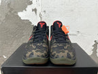 Front view of camouflage Nike Kobe basketball shoes with black laces and red tongue logos