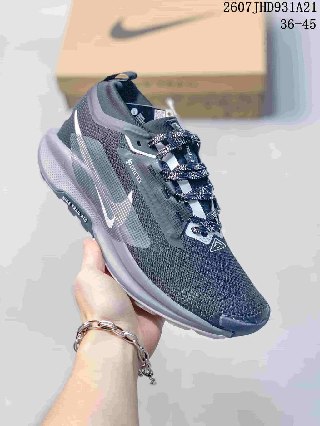 Angled side view of the dark gray trail sneaker showing the Nike logo, GORE-TEX marking, and layered outsole.