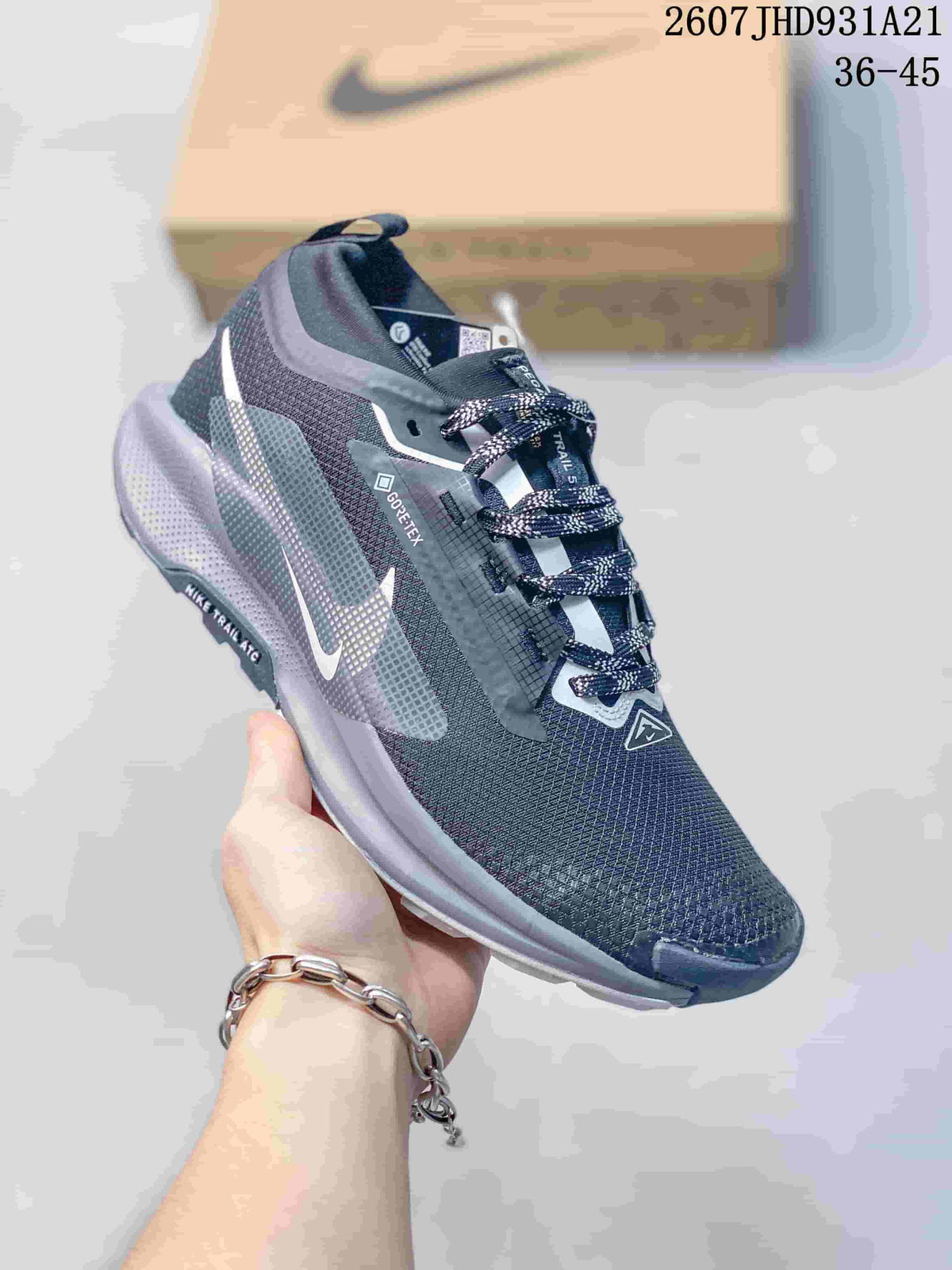 Angled side view of the dark gray trail sneaker showing the Nike logo, GORE-TEX marking, and layered outsole.